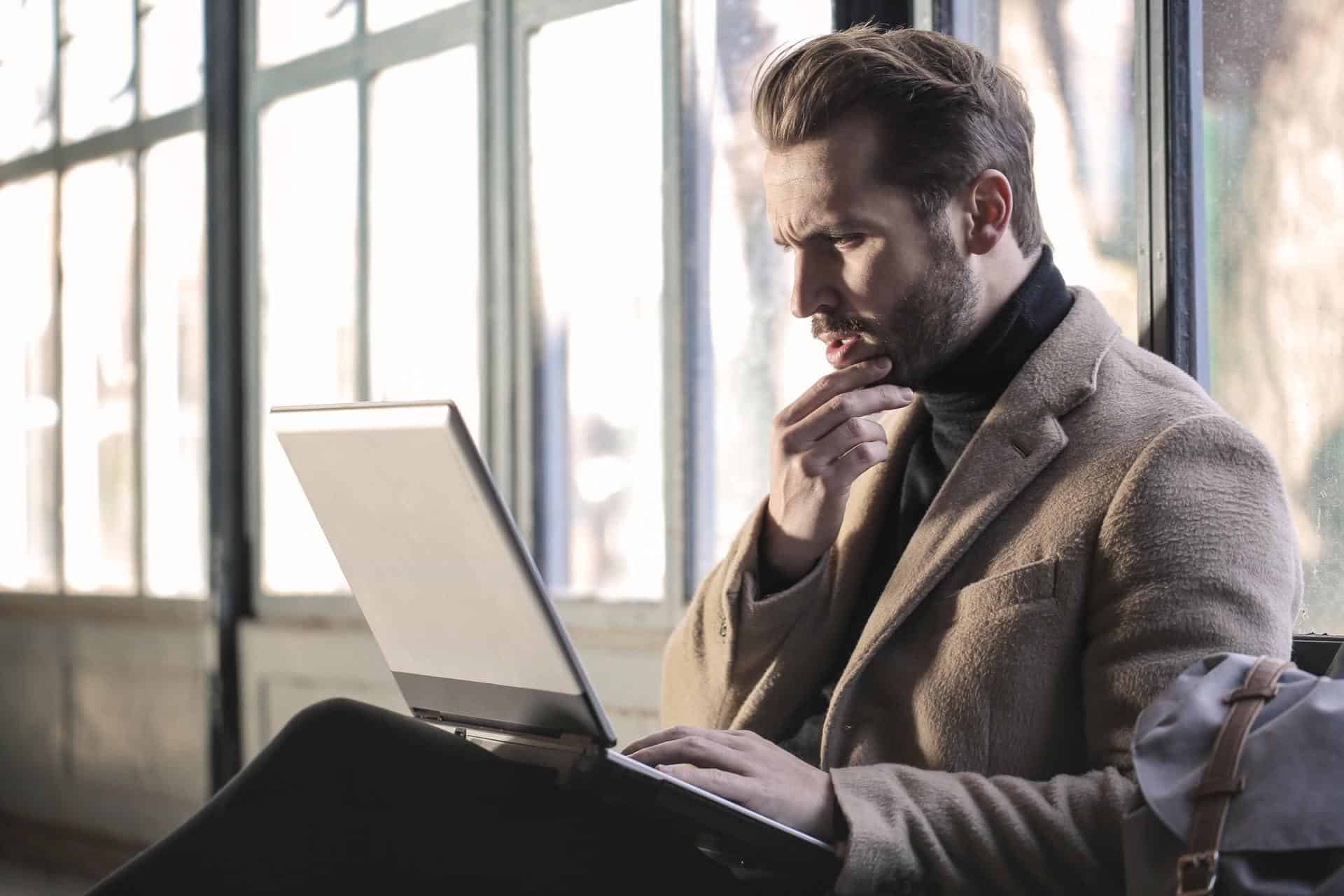 Man Thinking At Laptop