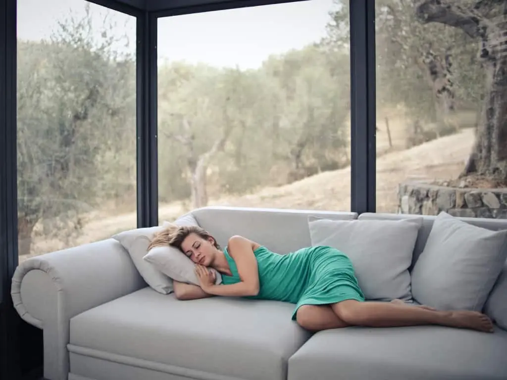 Woman Sleeping On Couch In Green Dress